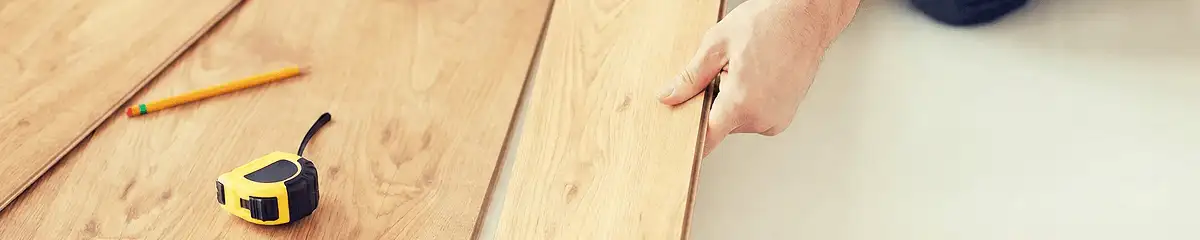 A professional installing wood flooring in Tucson, AZ