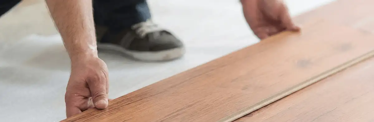 A professional installing laminate flooring in Tucson, AZ