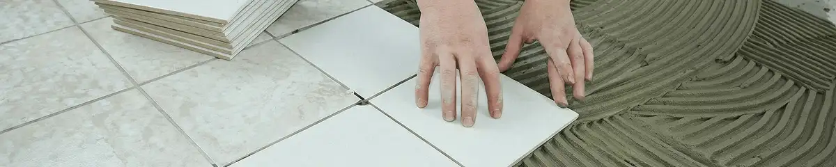 Professional installing white tile floors in Tucson, AZ