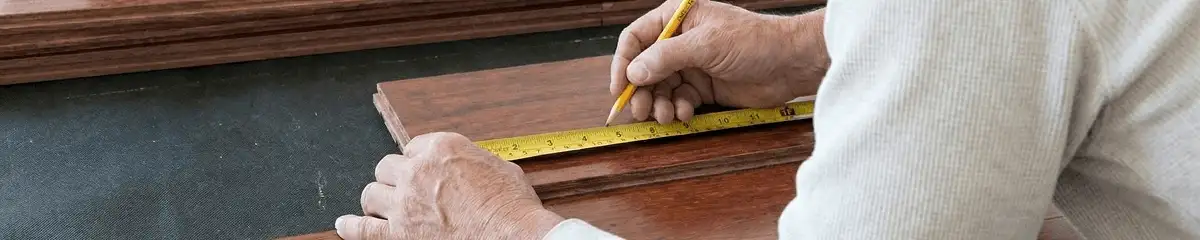A professional installing wood flooring in Tucson, AZ